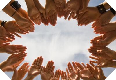 Stretched hands reaching for one another in a circle.