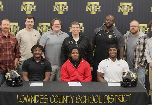 New Hope High School football coaches with seniors Tariq Butler, Jeremiah Harkins and Micah Butler