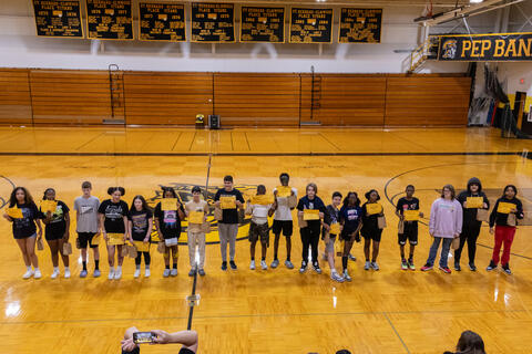 A large group of eighth-grade students pose together for a photo after receiving awards based on factors such as academic performance and attitude. 