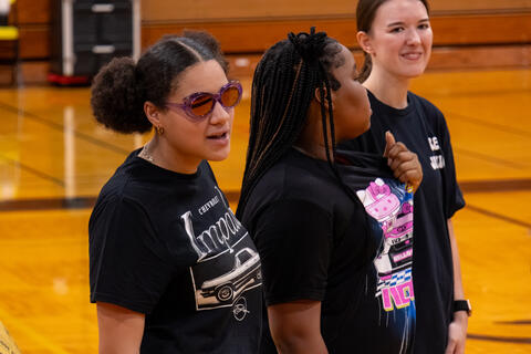 An eighth-grade student in sunglasses talks to someone who is off-camera. 