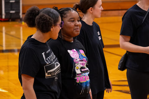 An eighth-grade student tries to hold in a laugh. 