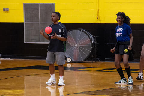 An eighth-grade student stands with a dodgeball during a game in the Jerry Radtke Gymnasium. 