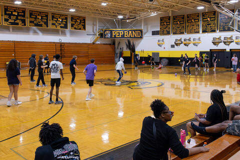 Eighth-grade students prepare themselves to play a game of dodgeball.