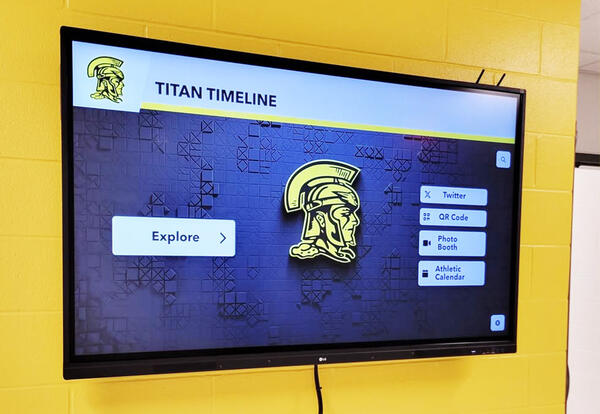 A touchscreen titled "Titan Timeline" hangs from the wall.
