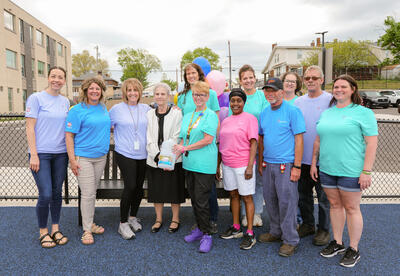 SBEP staff poses alongside members of B&G Foods during the unveiling of the new Buddy Bench.