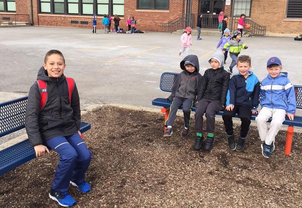 students sitting on new benches