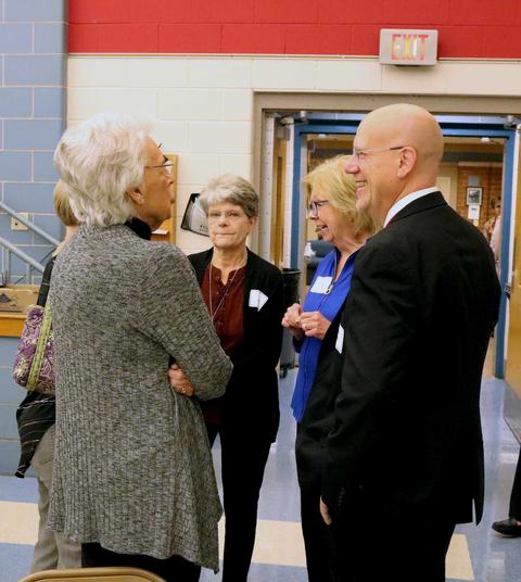 District 64 Superintendent Eric Olson chats with retired employees.