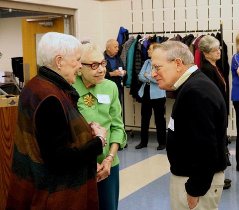 Retired District 64 employees chat at the breakfast in their honor.