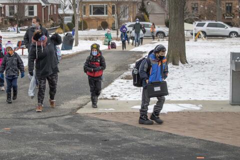 Roosevelt students file onto school grounds as in-person learning returns on Jan. 19.