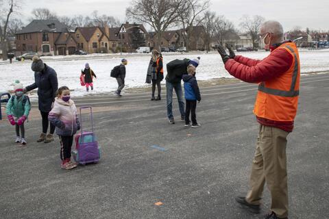 Roosevelt Principal Kevin Dwyer welcomes students back to school as in-person learning returns on Jan. 19.