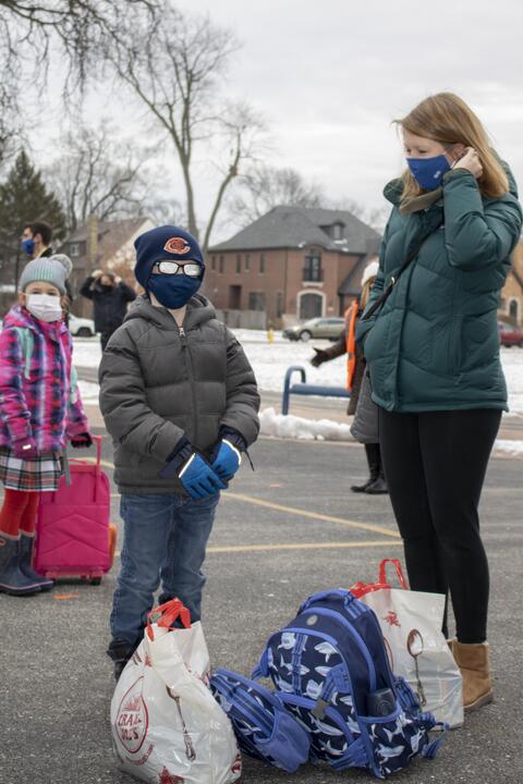 Parents of Roosevelt students bring their children to school grounds as in-person learning returns on Jan. 19.