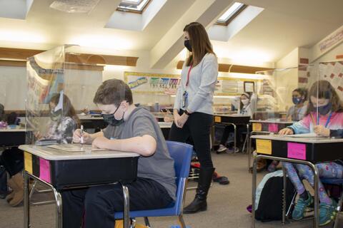 Roosevelt fifth-grade teacher Kristie Harvalis monitors students work on the first day back to in-person learning on Jan. 19.