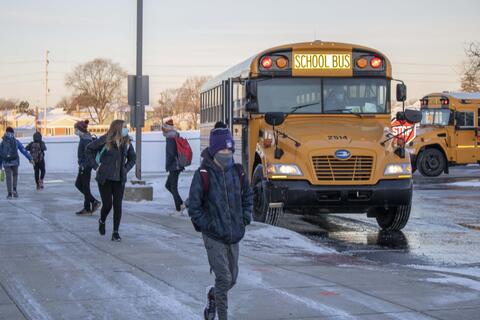 Emerson Middle School students walk from their bus to the school on Jan. 20 as in-person returned.