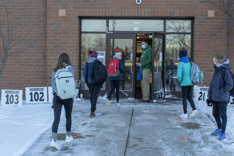 Emerson Middle School students file into the building on Jan. 20 as in-person learning returned.