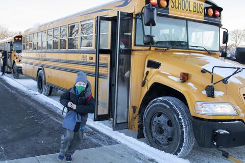 An Emerson Middle School student hurries from the bus to the school for the return of in-person learning on Jan. 20.