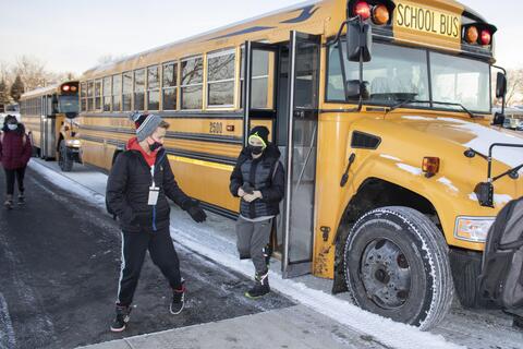 Emerson Middle School students file off the bus as in-person learning returns on Jan. 20.