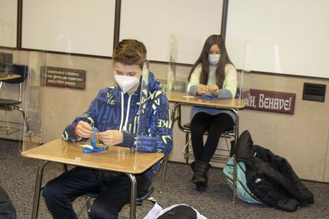 Emerson Middle School students add their name card to their health lanyards as in-person learning returns on Jan. 20.