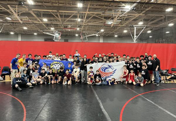 Local wrestling community gifts D64 athletes new uniforms