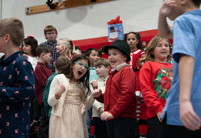 Students smiling during the Carpenter Holiday Sing