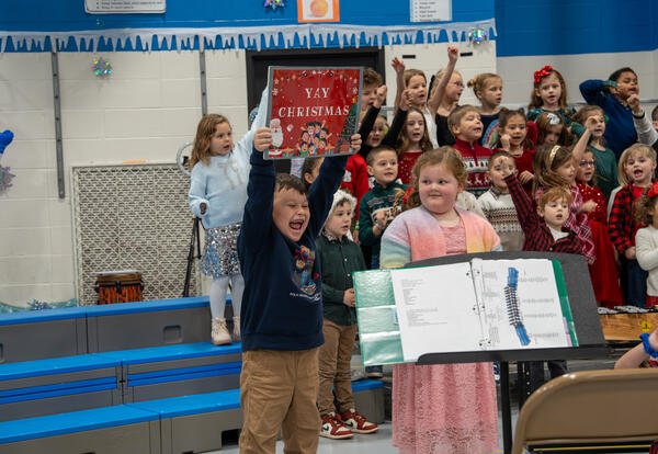 Franklin student holds up a sign that says "Yay Christmas"