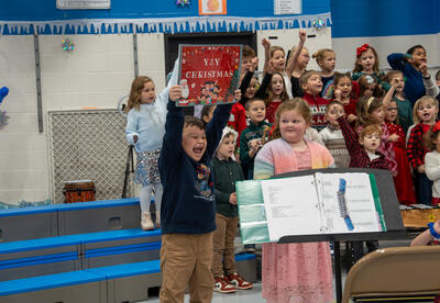Franklin student holds up a sign that says "Yay Christmas"