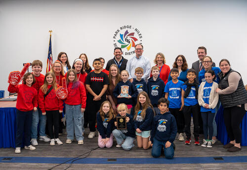 D64's Battle of the Books participants celebrating with the School Board