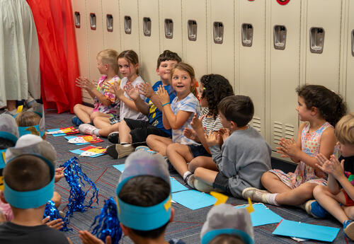 students clapping in the hall