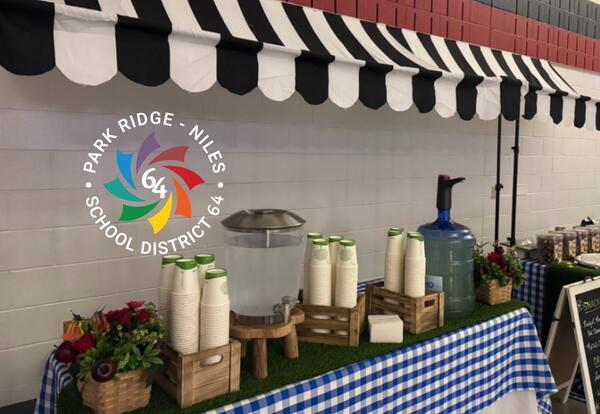 Table setup with compostable cups at school dance to promote sustainability at Emerson.