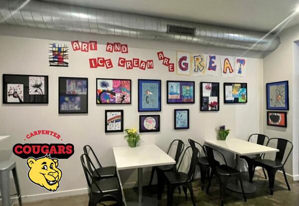 Triple Scoop'd Ice Cream Shop with black framed photos of Carpenter Elementary student's artwork hung up on the wall.