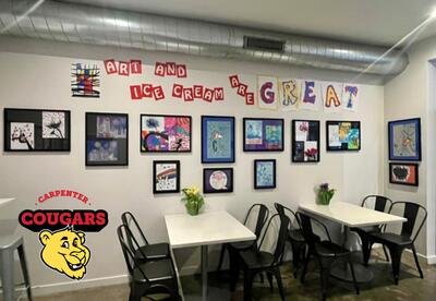 Triple Scoop'd Ice Cream Shop with black framed photos of Carpenter Elementary student's artwork hung up on the wall.