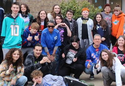 group of students posing in sports team shirts