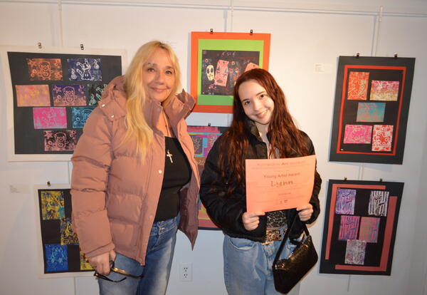 student, parent in front of art work