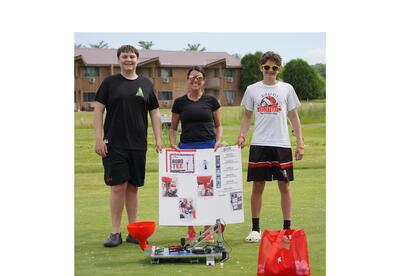 JRG teacher and students showing off ROBO-Tee at the 2026 KASD golf outing
