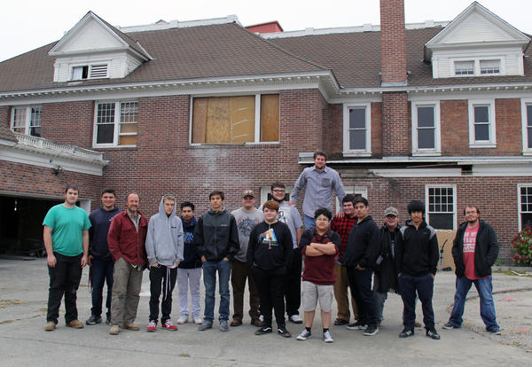 Student in the Wenatchee Valley Tech Construction Trade Program stand outside the Conrad Rose Mansion