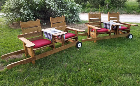 Wide shot of the 2 rolling chairs bench with table in between and accessories