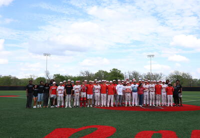 Red Ravens Baseball, NAMI on Campus students, Mike and Marcy Taylor of the Change4Conner Foundation, and Conner Taylor Memorial Award recipient Ethan Foley gather during the annual Conner Taylor Suicide Awareness Game on April 11.