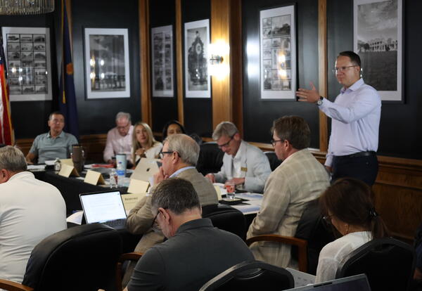 University of Kansas Director of Athletics and Vice Chancellor Travis Goff speaks in the CCC Community Room during a gathering of Kansas Board of Regents members, university presidents and CEOs, and higher education staff hosted by Coffeyville Community C
