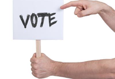 Hand holding vote sign