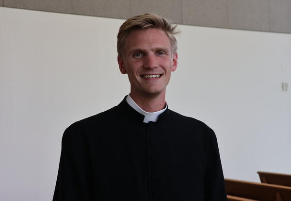 Father John Donart takes a photo.