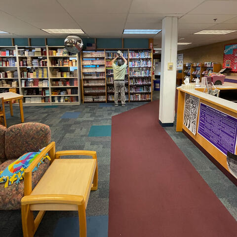 Mr. Henderson preps the library shelves