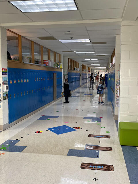 A long Middleton hallway fills slowly with students