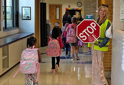 Photo of students and teachers in the hallway