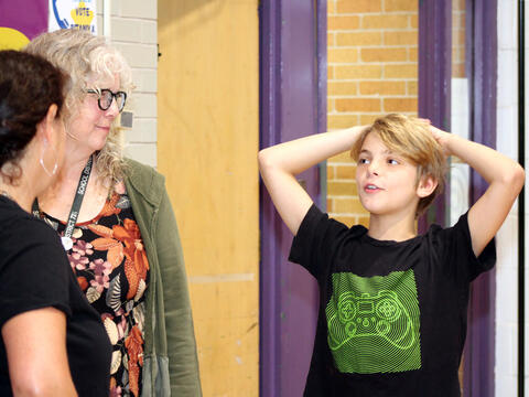 McCracken Librarian Mrs. Gammeri and author Dana Alison Levy chat with a student