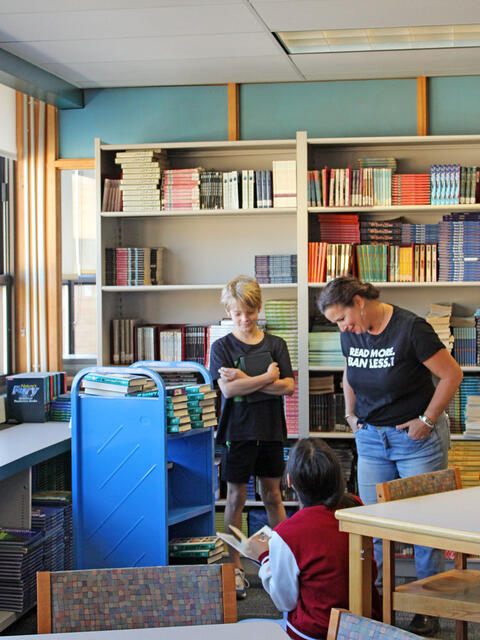 Photo of the author and students exploring the McCracken Library collection
