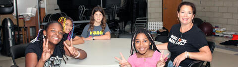 Students enjoying a pizza lunch with author Dana Alison Levy