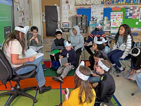 photo of teacher and students engaged in a 6 7 Day activity