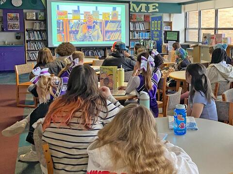 photo of students viewing a video message