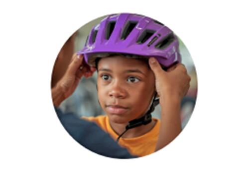 Photo of child getting their bike helmet fitted