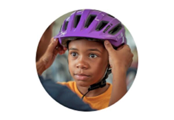 Photo of child getting their bike helmet fitted