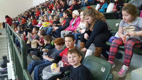 students and staff at basketball game